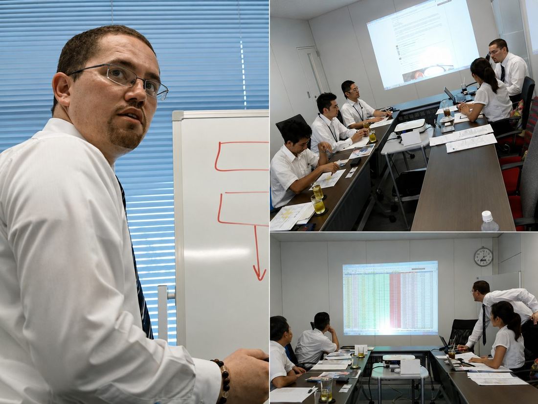 創業初期、日本のビジネスリーダーの方々と提案資料・比較スライドを確認するアダム・ジョーンズ ─ 小さな会議室での打ち合わせ。